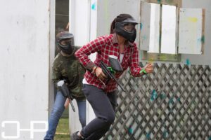 two girls running during paintball game