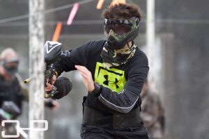 boy running during paintball game