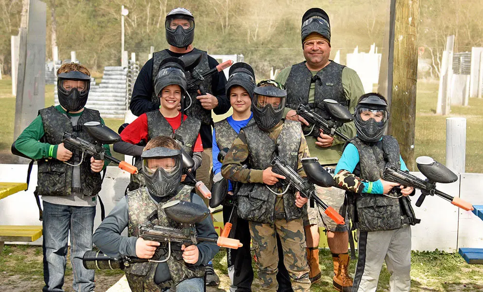 people wearing paintball gear and holding paintball guns