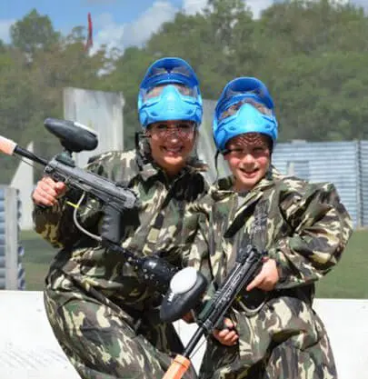 two girls wearing paintball gear
